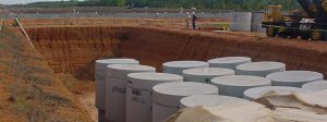 Large metal casks of nuclear waste in a pit in the ground