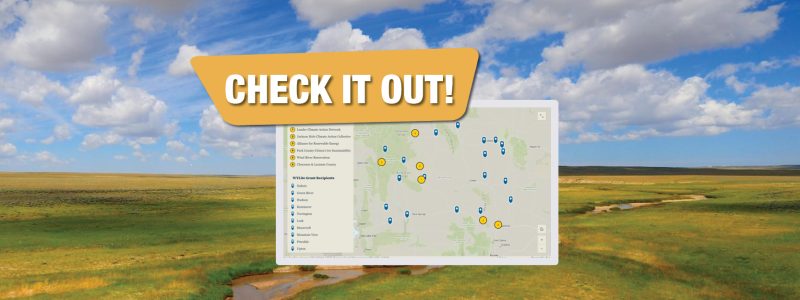 Map showing various cities in Wyoming where local climate action has happened, overlaid on photo of vast, green, hilly landscape and blue sky with clouds. The words "CHECK IT OUT" are above the map.
